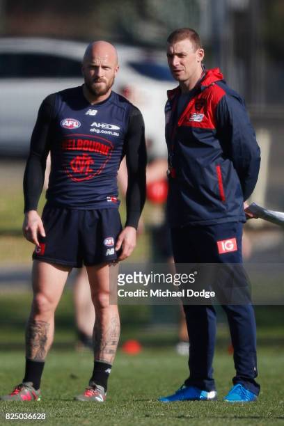 Nathan Jones of the Demons talks with Demons head coach Simon Goodwin during a Melbourne Demons AFL training session at Gosch's Paddock on August 1,...