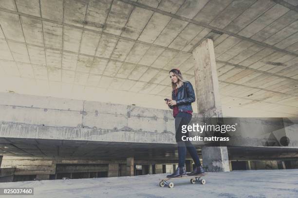 teenage girl listening to music on her skateboard - gangster girl stock pictures, royalty-free photos & images