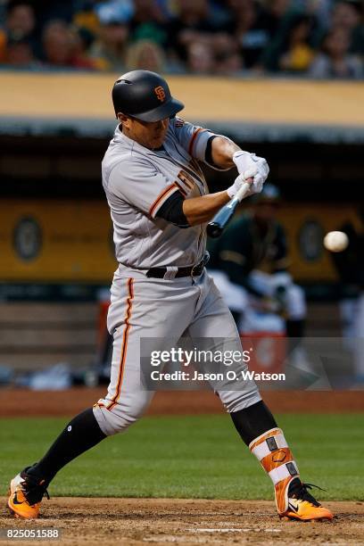 Jae-Gyun Hwang of the San Francisco Giants hits an RBI single against the Oakland Athletics during the fourth inning at the Oakland Coliseum on July...