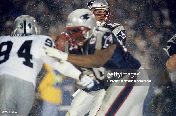 New England Patriots tackle Greg Robinson-Randall does battle with Raiders defensive end Tony Bryant while quarterback Tom Brady looks for an open...