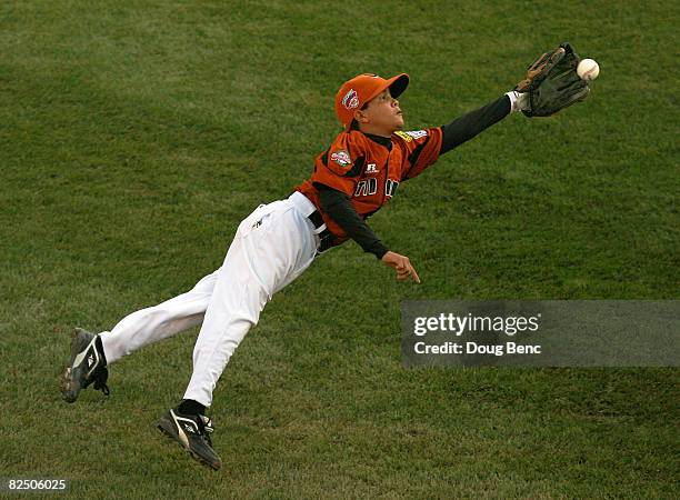 Second baseman Carlos Machado of Latin America dives to catch a line drive against Mexico during the international semi-final at Lamade Stadium on...