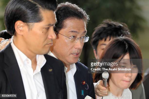Japanese Foreign and Defense Minister Fumio Kishida enters the Prime Minister's official residence for attending the National Security Council on...