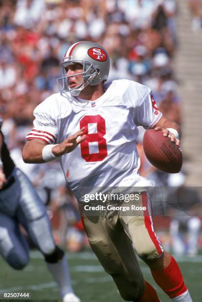 Quarterback Steve Young of the San Francisco 49ers looks to pass against the Los Angeles Raiders during a game at the Los Angeles Memorial Coliseum...