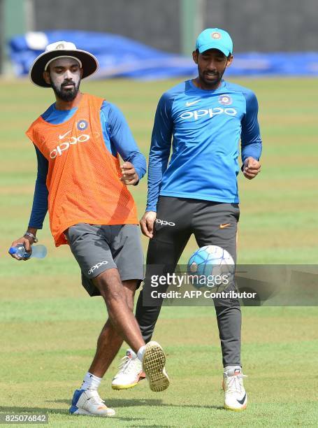 India's cricketer Lokesh Rahul plays football with teammate Wriddhiman Saha during a practice session at the Sinhalease Sports Club Ground in Colombo...