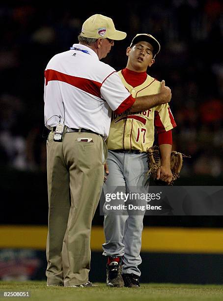 Manager Joe McGuire of the Southeast talks with his son, the starting pitcher Michael McGuire after pulling him from the game while taking on the...