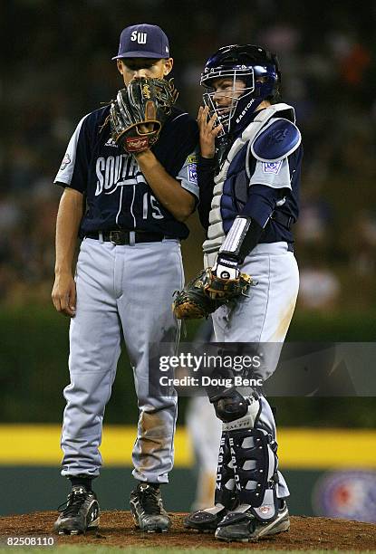 Starting pitcher Kennon Fontenot and catcher Beau Jordan of the Southwest talk during a time-out while taking on the Southeast during the United...