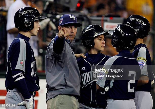 Manager Charlie Phillips of the Southwest talks with his team during a pitching change against the Southeast during the United States semi-final at...