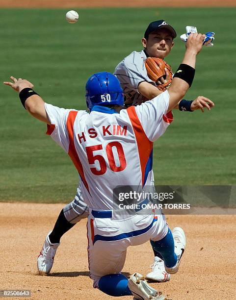 Japanese shortstop Munenori Kawasaki throws to first for a doubleplay after forcing out South Korea's Kim Hyun-soo in the fourth inning of their...