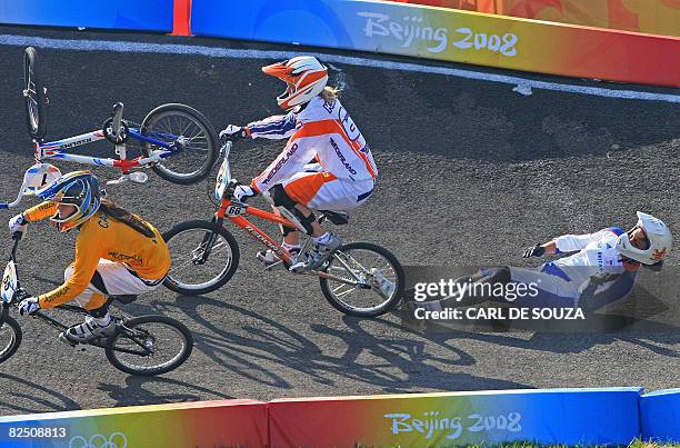 Britain's Shanaze Reade falls while Nicole Callisto of Australia and Lieke Klaus of the Netherlands race past during the semi-final heat in the...