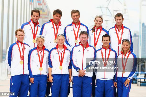 Great Britain sailing team medal winners and Team GB sailing leader Stephen Park pose with their medals at the Qingdao Olympic Sailing Center during...