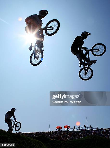 Raymon van der Biezen of the Netherlands and Sifiso Nhlapo of South Africa get air during the Men's BMX semifinal run held at the Laoshan Bicycle...