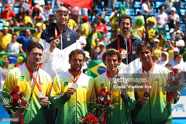 Ricardo Santos, Emanuel Rego, Marcio Araujo and Fabio Magalhaes of Brazil, along with Philip Dalhausser and Todd Rogers of the United States hold...