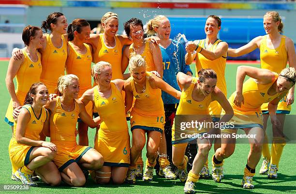 Nicole Arrold of Australia douses her teammates with a bottle of water during the team photo after their 2-0 victory over Great Britain in the...