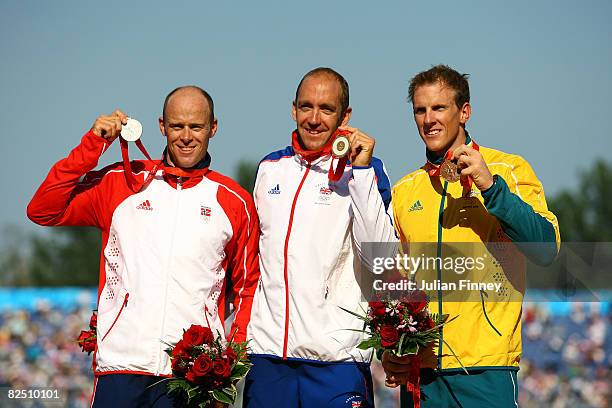 Silver medalist Eirik Veraas Larsen of Norway,gold medalist Tim Brabants of Great Britain and Ken Wallace of Australia receive their medals on the...