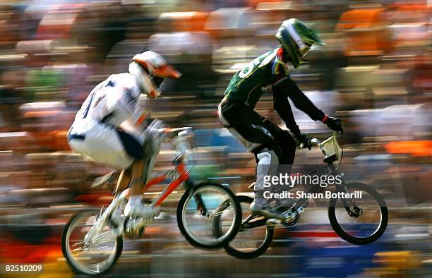 Sifiso Nhlapo of South Africa and Raymon van der Biezen of the Netherlands compete in the Men's BMX semifinal run held at the Laoshan Bicycle Moto...