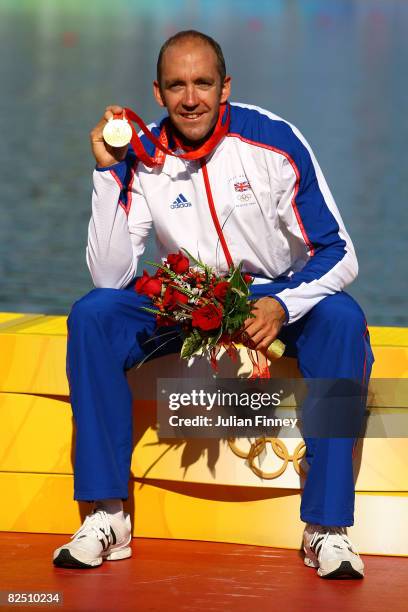 Gold medalist Tim Brabants of Great Britain receives his gold medal on the podium during the medal ceremony for the men's flatwater kayak single...