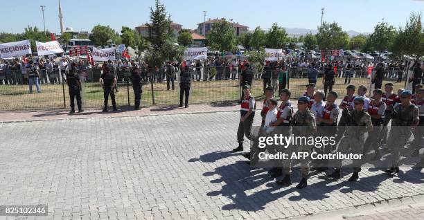 Defendants Kemal Batmaz and Akin Ozturk and other defendants are accompanied by gendarmerie as they arrive for their trial at Sincan Penal...