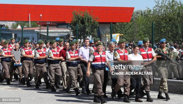 Defendants Kemal Batmaz and Akin Ozturk and other defendants are accompanied by gendarmerie as they arrive for their trial at Sincan Penal...