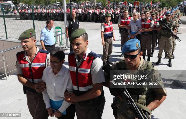 Defendants Kemal Batmaz and Akin Ozturk and other defendants are accompanied by gendarmerie as they arrive for their trial at Sincan Penal...