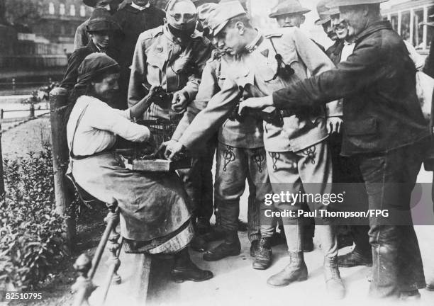 Austro-Hungarian troops have their fortunes told by a gypsy fortune teller in Budapest, before leaving to face the Russians during World War I, circa...