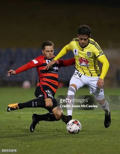 Logan Rogerson of the Phoenix is challenged by Josh Risdon of the Wanderers during the FFA Cup round of 32 match between the Western Sydney Wanderers...