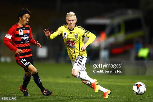 Jumpei Kusukami of the Wanderers and Adam Parkhouse of the Phoenix challenge for the ball during the FFA Cup round of 32 match between the Western...