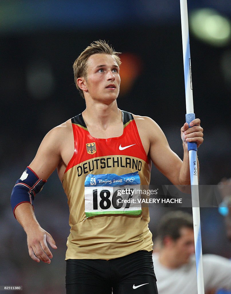 Germany's Michael Schrader looks at his score after competing in the