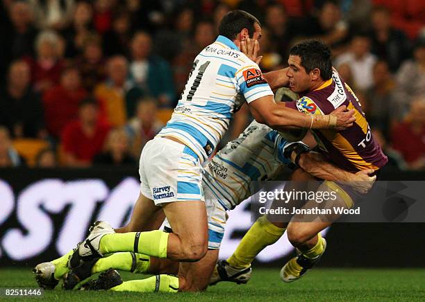 Corey Parker of the Broncos is tackled during the round 24 NRL match between the Brisbane Broncos and the Gold Coast Titans at Suncorp Stadium on...