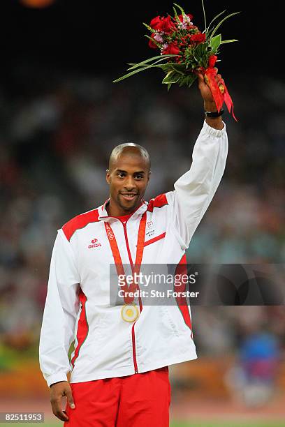 Gold medalist Nelson Evora of Portugal celebrates on the podium during the Men's Triple Jump medal ceremony at the National Stadium on Day 14 of the...