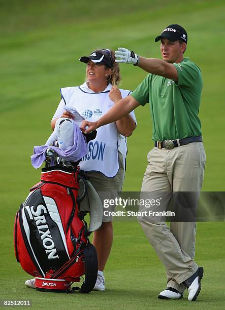 Henrik Stenson of Sweden land caddie Fanny Suneson on the second hole during second round of The KLM Open at Kennemer Golf & Country Club on August...