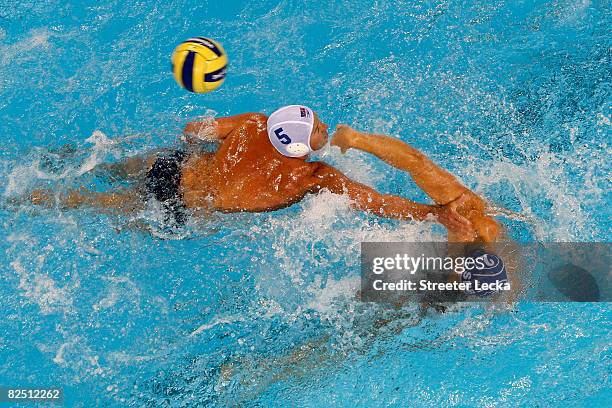 Andrija Prlainovic of Serbia passes the ball over Adam Wright of the United States looks to pass over in the men's semifinal water polo match at the...