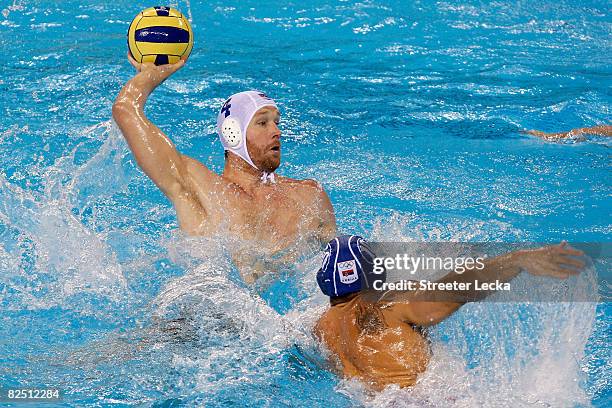 Jeffrey Powers of the United States looks to pass over Aleksander Sapic of Serbia in the men's semifinal water polo match at the Yingdong Natatorium...