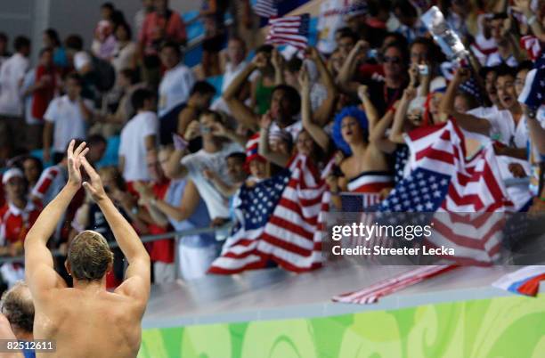 Fans cheer for the United States after they defeated Serbia in the men's semifinal game of the water polo event at the Yingdong Natatorium on Day 14...