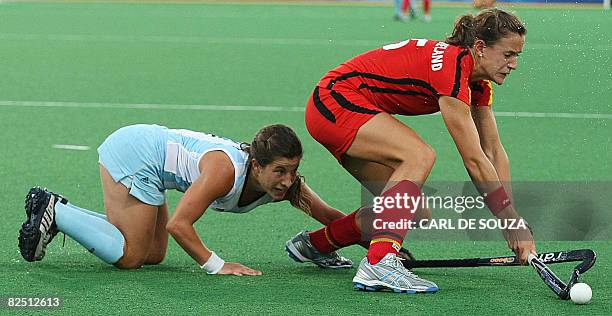 Germany's Janne Mueller-Wieland and Argentina's Mariana Gonzalez Oliva fight for the ball during their women's hockey bronze medal match at the...