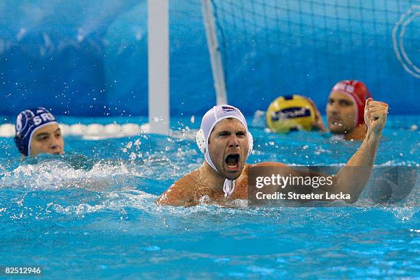 Rick Merlo of the United States celebrates a goal over Serbia in the men's semifinal game of the water polo event at the Yingdong Natatorium on Day...