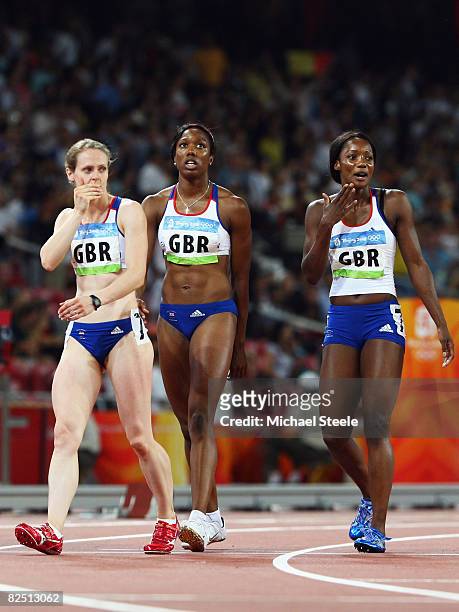 Emily Freeman, Montell Douglas and Emma Ania of Great Britain look on after the Women's 4 x 100m Relay Final at the National Stadium on Day 14 of the...