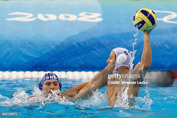 Peter Varellas of the United States goes up for a shot against Serbia in the men's semifinal water polo match at the Yingdong Natatorium on Day 14 of...