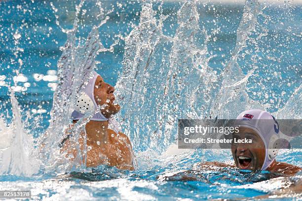 Peter Varellas and Adam Wright of the United States celebrate after they defeated Serbia in the men's semifinal game of the water polo event at the...