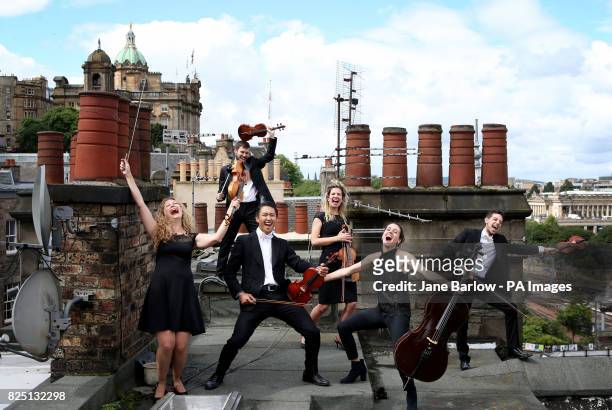 Members of the Catalonian string orchestra Orquestra de Cambra d'emporia perform on the roof tops of Craig's Close in Edinburgh's Old Town ahead of...