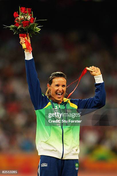 Gold medalist Maurren Higa Maggi of Brazil celebrates on the podium during the medal ceremony for the Women's Long Jump Final at the National Stadium...
