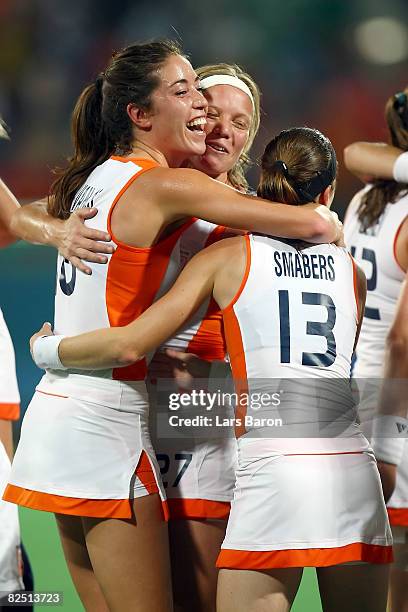 Naomi Van As, Marilyn Agliotti and Minke Smabers of the Netherlands celebrate after their 2-0 victory over China in the women's gold medal hockey...