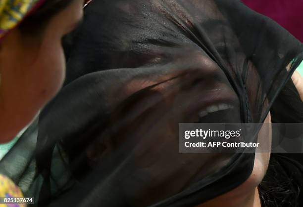 Relative of Kashmiri civilian Firdous Ahmed mourns during his funeral at Begum Bagh Pulwama, south of Srinagar, on August 1, 2017. Indian forces...