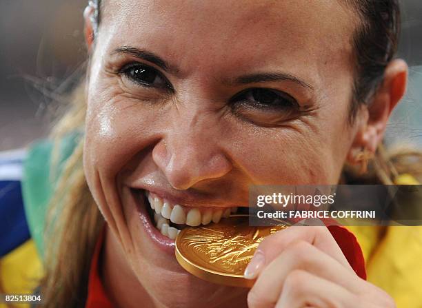 Brazil's Maurren Higa Maggi poses with her gold medal on the podium during the women's long jump medal ceremony at the "Bird's Nest" National Stadium...