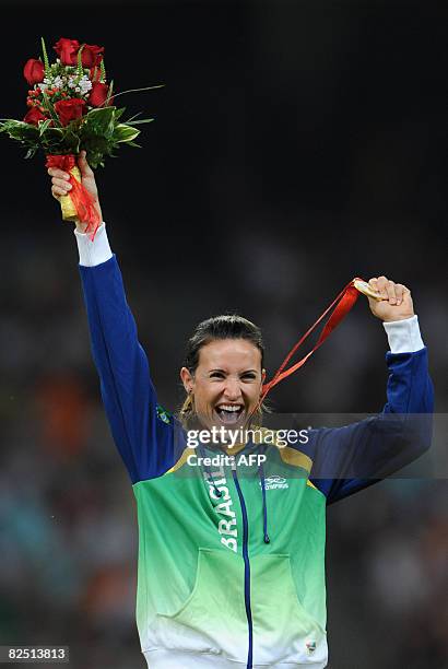 Brazil's Maurren Higa Maggi poses with her gold medal on the podium during the women's long jump medal ceremony at the "Bird's Nest" National Stadium...