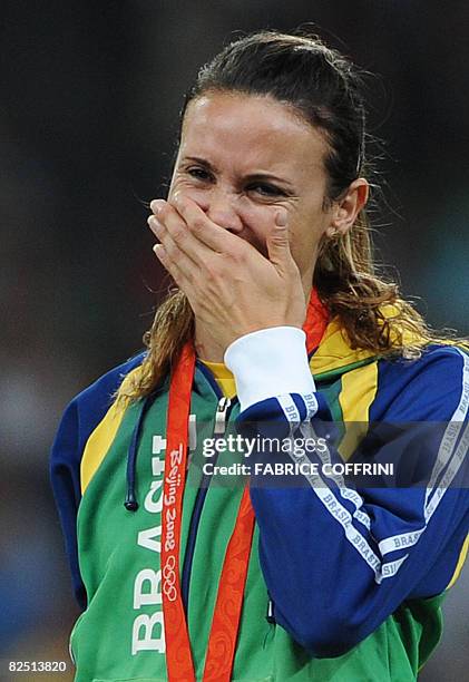 Brazil's Maurren Higa Maggi cries on the podium during the women's long jump medal ceremony at the "Bird's Nest" National Stadium during the 2008...
