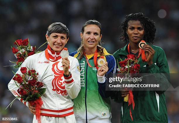 Russia's Tatiana Lebedeva with her silver, gold medallist Brazil's Maurren Higa Maggi and bronze Nigeria's Blessing Okhagbare pose on the podium...