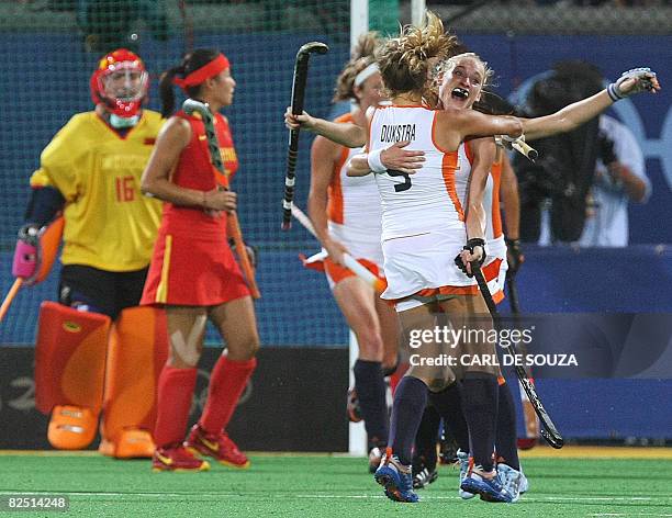 Netherland's Wieke Dijkstra and goal scorer Maartje Goderie celebrate after winning their women's field hockey final China of the 2008 Beijing...