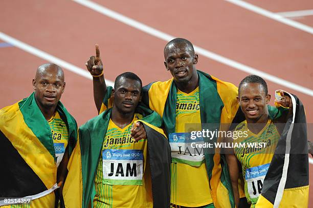 Jamaica's Asafa Powell, Nesta Carter, Usain Bolt and Michael Frater celebrate after winning the men's 4?100m Relay final at the National Stadium...