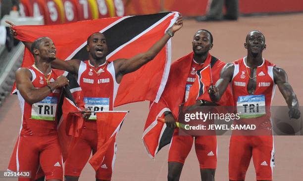 Trinidad and Tobago's Keston Bledman, Emmanuel Callender, Richard Thompson and Marc Burns celebrate after winning silver in the men's 4?100m Relay...