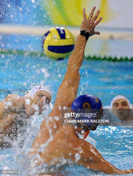 Peter Biros from Hungary shoots for goal as Aleksandar Ivovic from Montenegro attempts to block during their semifinal waterpolo match of the 2008...